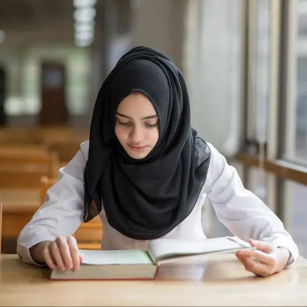 young girl reading Quran